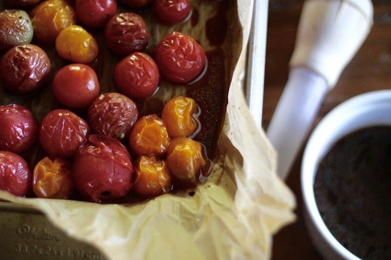 Grab the liquids from the roasted tomatoes with a turkey baster as seen here. Then, simmer on the stove in a small sauce pan until the volume is reduced by half. This is your balsamic reduction.