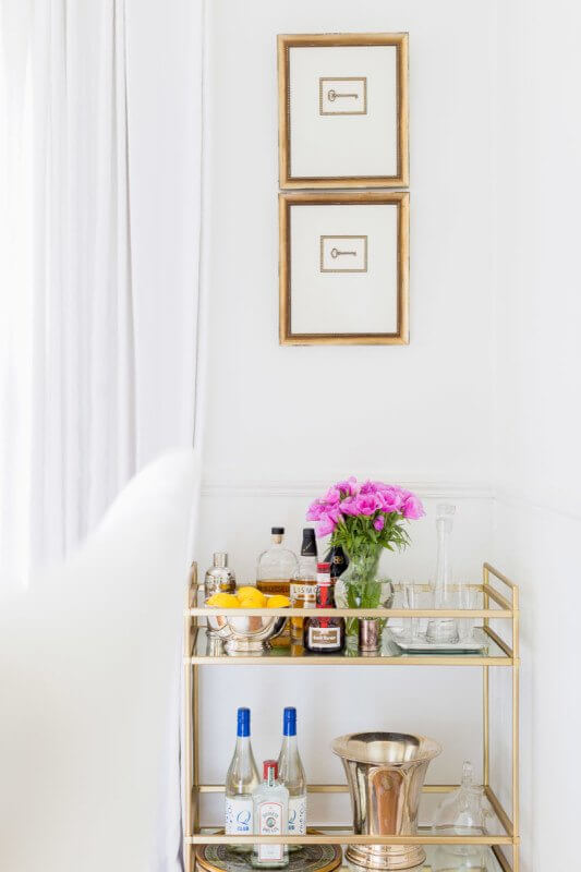 This Renovated Cottage Has Big Appeal - 7 A rolling bar is not only a chic wall accent, but it also is a great entertaining piece when guests are present. photo credit: @AlyssaRosenheck