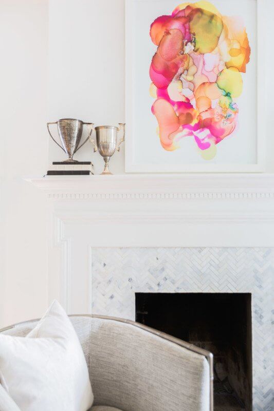 This Renovated Cottage Has Big Appeal - 3 A vibrant splash of color is introduced in a contemporary painting placed above the mantel. photo credit: @AlyssaRosenheck