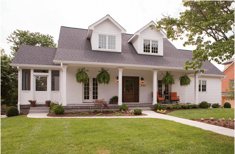 The renovated exterior of the home now includes a front porch, an ideal space for welcoming and entertaining guests.