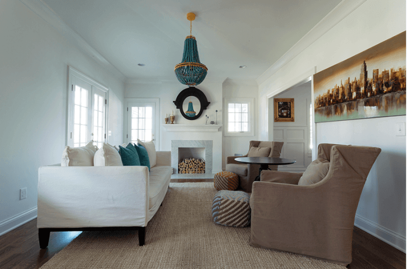 Note how the homeowners introduced geometric patterns of reds and blues in the covered ottomans.