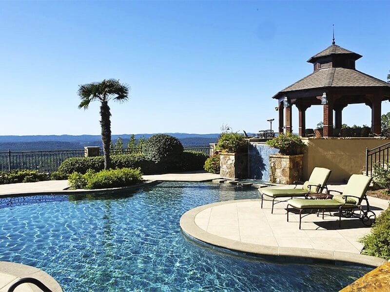 The crystal-blue sunlit pool waters are a favorite hangout for the homeowners and their family, who all love to spend weekend days and evenings—cooking out, splashing and lounging together.
