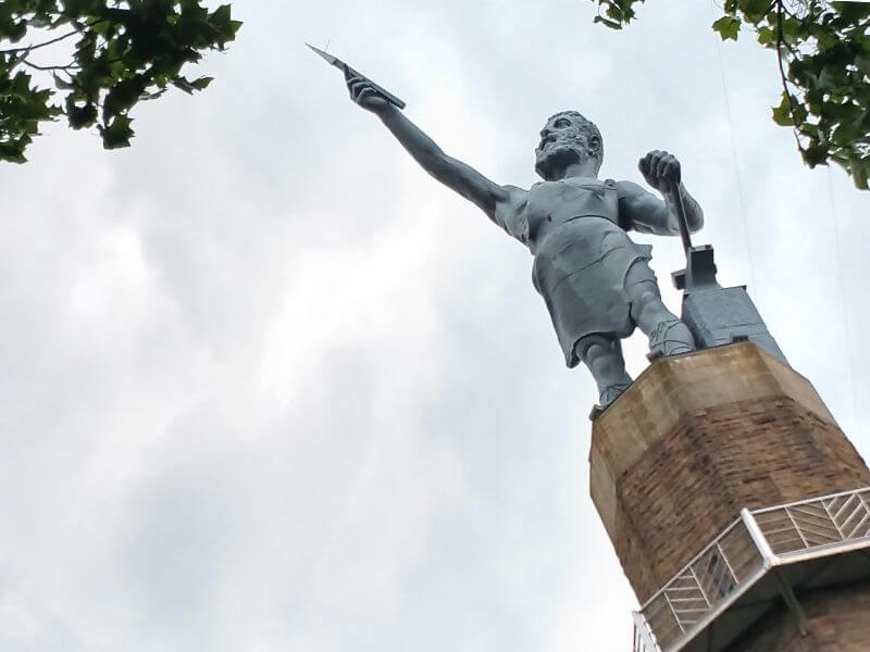 The statue of Vulcan, the Roman god of fire and forge, is a signature Birmingham landmark and homage to our city's roots as a once major iron and steel town. In 1903, city leaders decided to erect a statue of the Roman god as a way to market Birmingham's booming industry at the St. Louis World's Fair. Italian sculptor Guiseppe Moretti made a full-size clay model, which was shipped to Birmingham and cast in iron at Sloss Furnaces. The massive statue was then shipped to the St. Louis World Fair, where it won the grand prize in the mineral category. The statue was first erected on the Alabama State Fairgrounds in 1906.