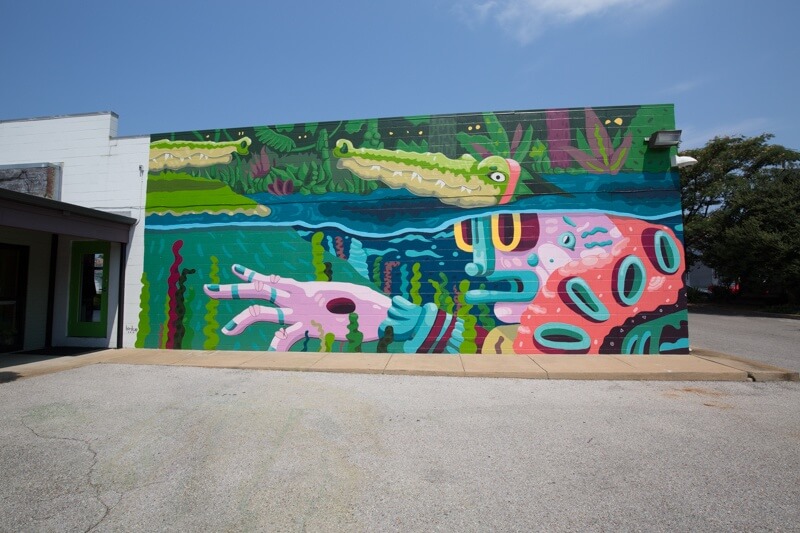 Found on the side of the Eclectic Eye at Cooper and Peabody, "Birdcap Underwater" by Michael Roy offers a magnified view of a bayou-type water scene, complete with a pair of crocs.