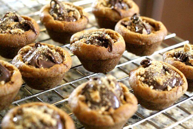 S'mores cookie cups with Nutella and marshmallows: Fill each cookie cup with Nutella and sprinkle some graham cracker crumbs across the top.
