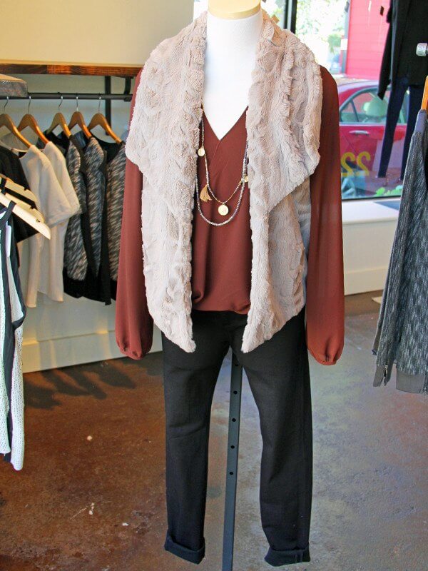 A vest and necklace add interested layers to a basic silk top. From "What to Wear - Nashville Events"