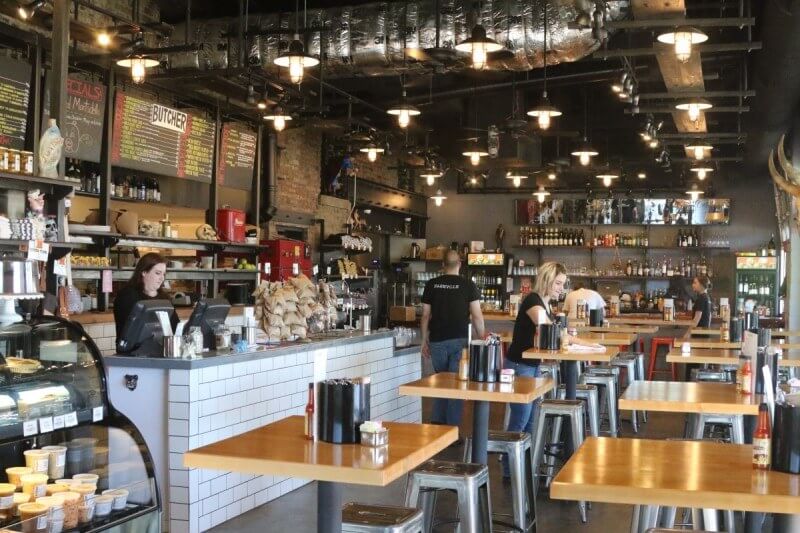 The interior of Cochon Butcher makes an "L" shape and includes the sandwich and small platers counter to order, the meat counter for take-outs and the bar. The covered patio at least doubles the seating capacity.