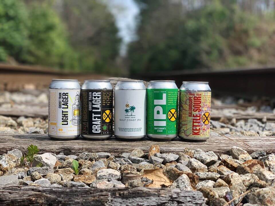 Brews by Ghost Train Brewing Company made right here in the Magic City. Image: Ghost Train Brewing Company Beer cans from Ghost Train Brewing Company, a Birmingham craft brewery, on railroad tracks