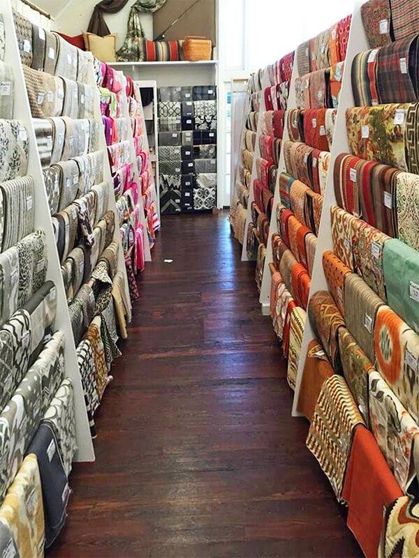 The richly hued original hardwood floor gleams against the rainbow of fabrics.