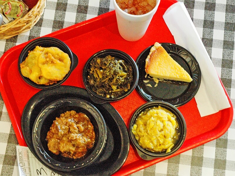 Is there anything more Southern than a tray of smothered chicken livers, fried green tomatoes, collard greens, squash, buttermilk pie and a nice cold iced tea?