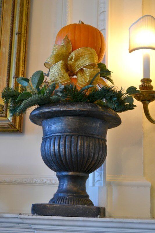 Pumpkin topiary made with two mini-pumpkins, dowel rods and a handmade bow.