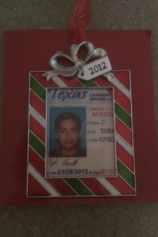 Craft stores sell these photo frame ornaments and you can place the license or school ID within. Or, you can simply punch a hole in it, add a ribbon, and be done!