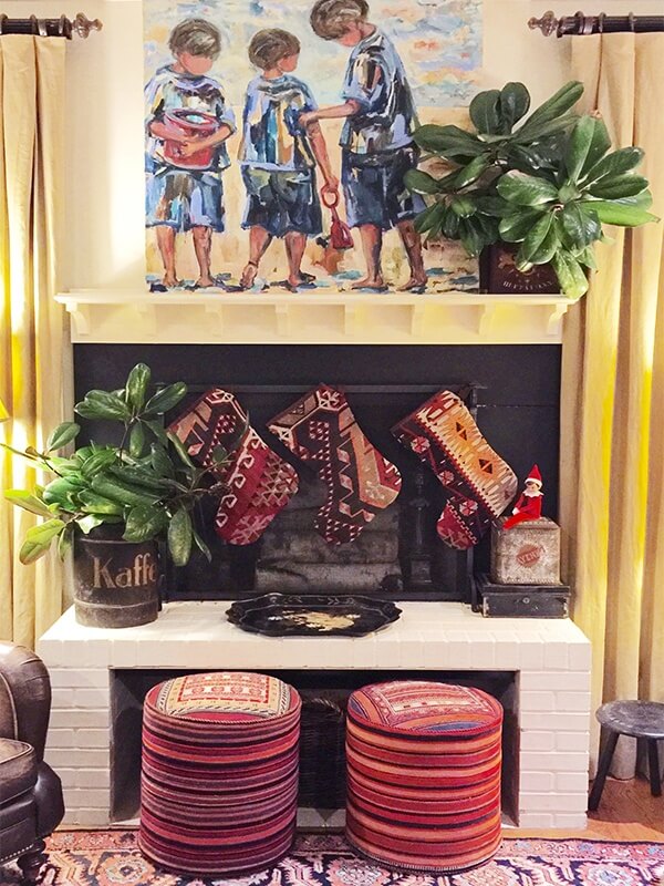 A more casual scene, these colorful kelim stockings and stools are perfect against this back and white hearth.