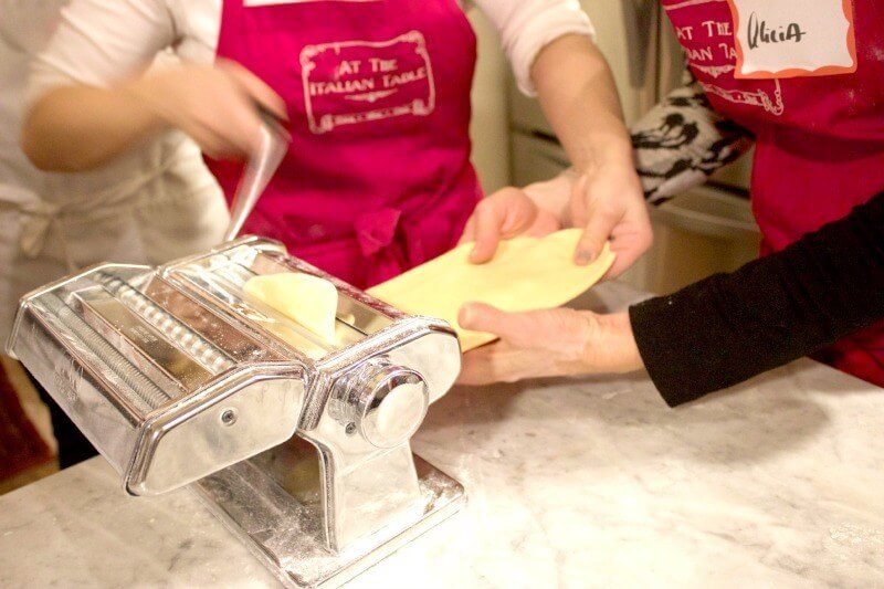 At The Italian Table with Gina Stipo. The pasta dough takes its first pass through the roller