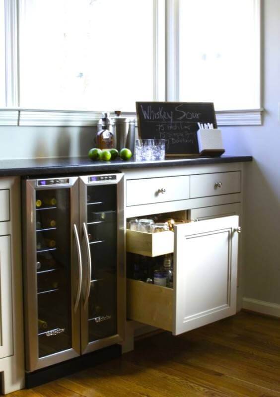 The homeowners utilize every inch of space for entertaining guests. sophisticated farmhouse kitchen bar