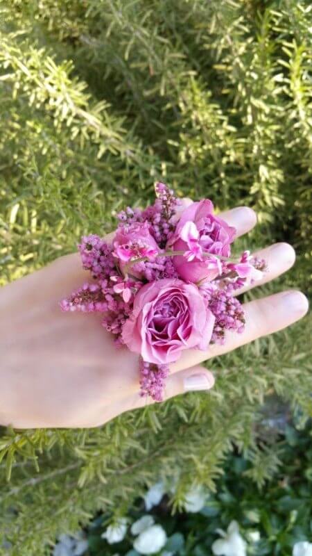 Ring corsage made with lavender roses and heather with hot pink genestra. Find more examples of ring corsages on StyleBlueprint.com