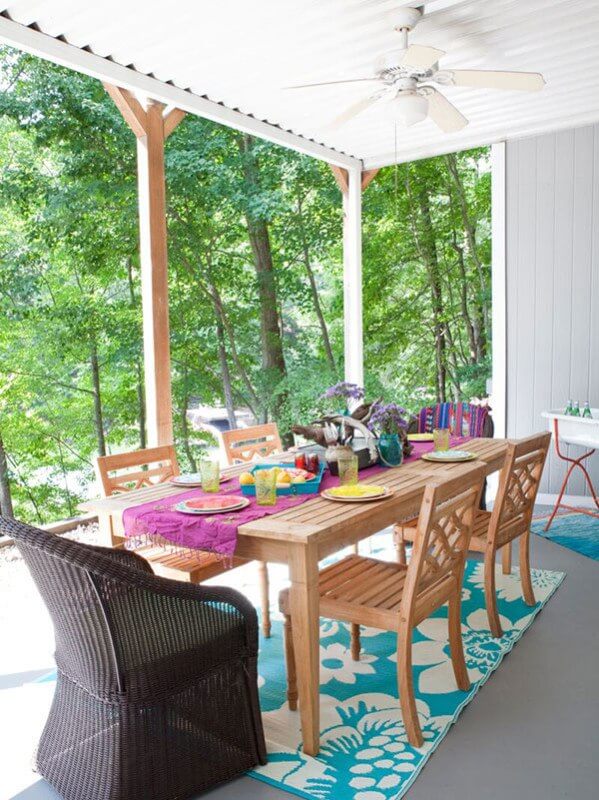 Eating outside, among the lush trees, gives the effect of living in a treehouse! This Lake Lanier home is also wheelchair accessible. Interior designer: Beth Johnson
