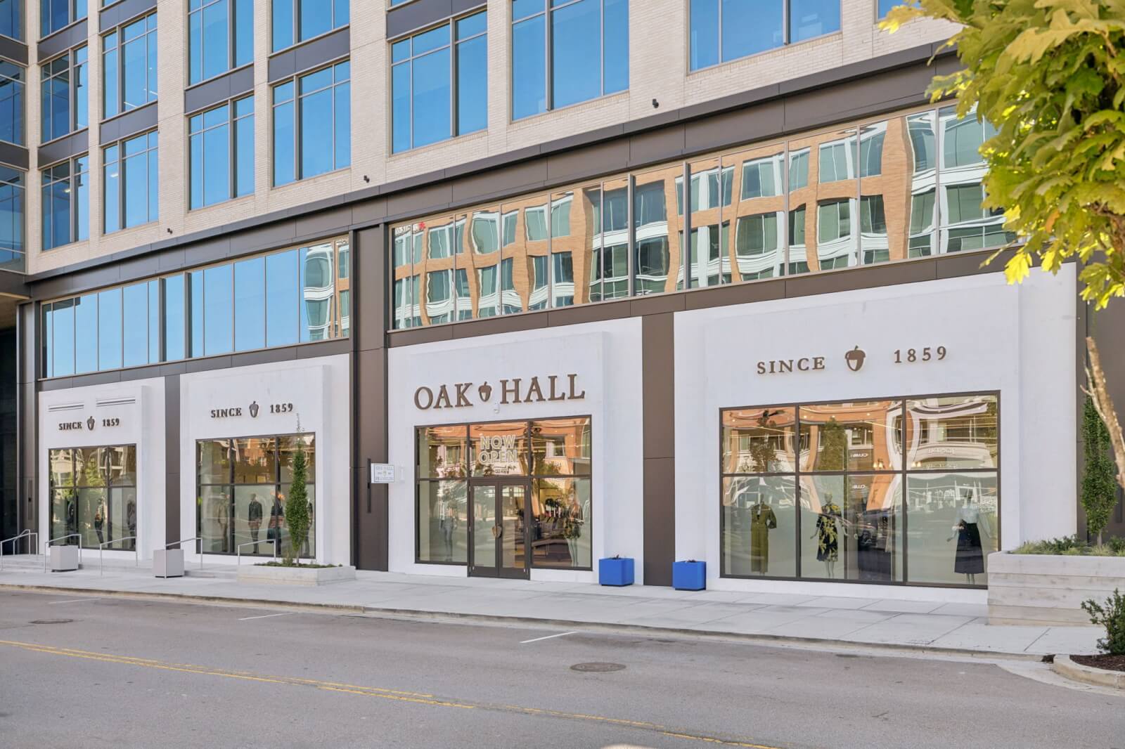 Street view of the Oak Hall storefront with large glass windows, modern architecture, and "Since 1859" displayed on the Oak Hall facade.