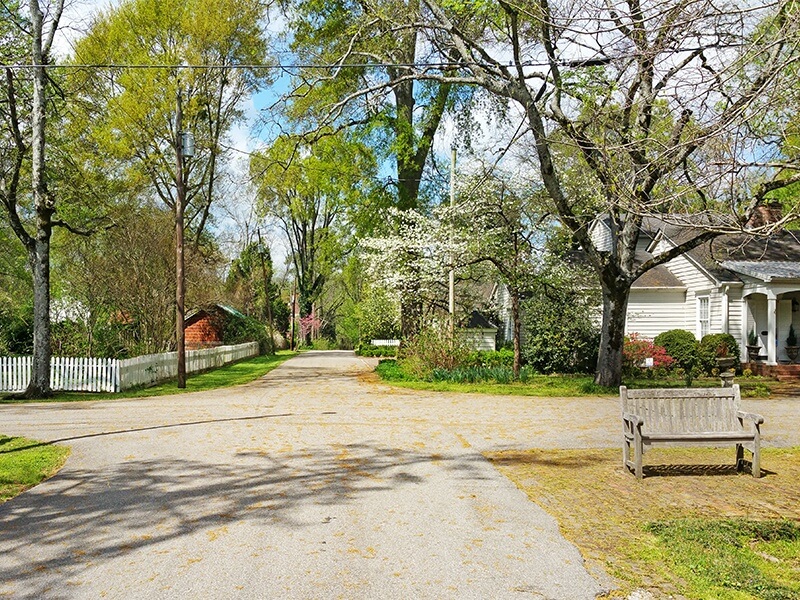 One of the town's few crossroads offers an idyllic view with picket fences, porches, flowers in bloom and a bench to stop and soak in the beauty of it all!