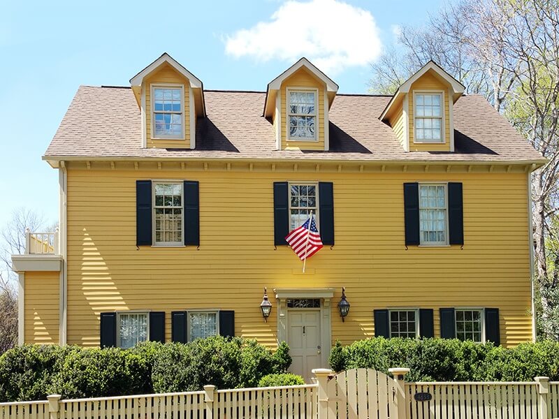 Built in 1988, this home is a replica of the Crowninshield Bentley house built in 1730 in Salem, Massachusetts. Its vibrant yellow paint job dates to 1995, when it played a role in the Disney movie, "Tom and Huck."