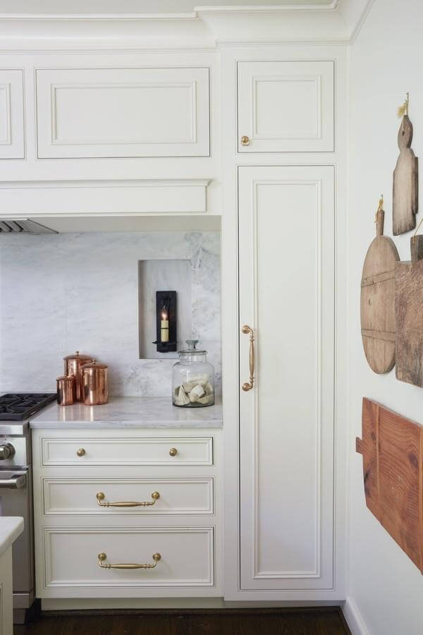 "We chose to recess the sconces into marble niches for dramatic effect," says Cyndy. The sconces exude an old-world ambience that gives the kitchen a warm glow in the evenings. The homeowners collection of vintage and antique cutting boards are used for entertaining guests as well as gorgeous wall art! "We chose to recess the sconces into marble niches for dramatic effect," says Cyndy. The sconces exude an old-world ambience that gives the kitchen a warm glow in the evenings. The homeowners collection of vintage and antique cutting boards are used for entertaining guests as well as gorgeous wall art!