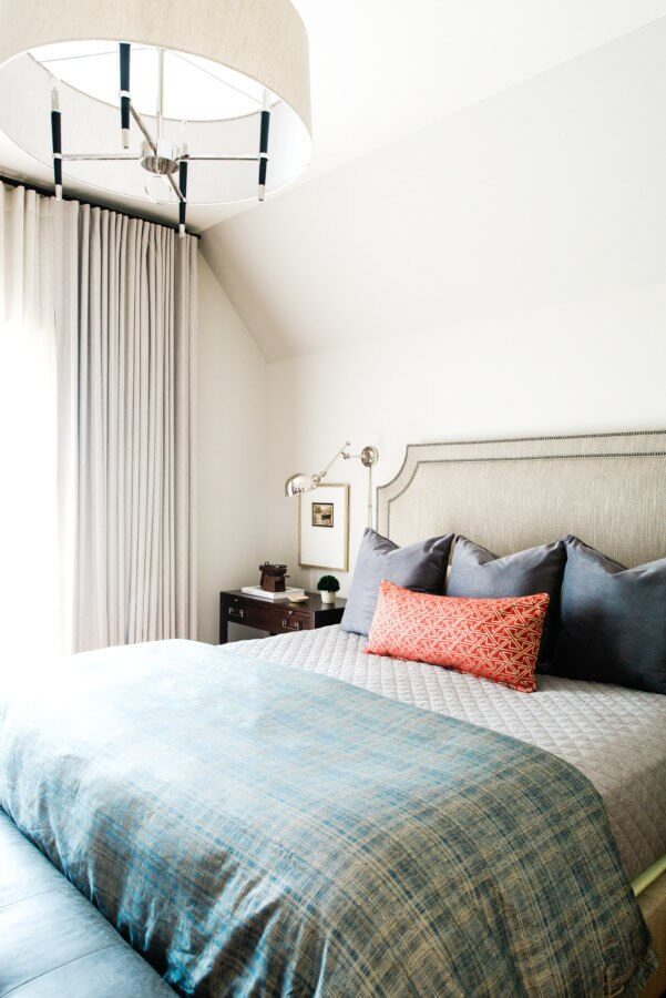 Upstairs, the master bedroom features the same paint color as the downstairs but the aesthetics differ. "The space is masculine, yet polished," Bob says of the bedroom. "It is a room you can turn into a cave but it can also be bright and inviting." 