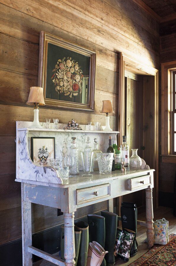 The family has found multiple uses for this antique dry bar in this high-traffic hallway entrance.