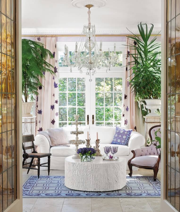 "In the 19th-century Litchfield home of interior designer and style author Florence de Dampierre, French doors with amber-colored glass open from a formal sitting room to a luminous conservatory," says Susan. "While the dark wood of antique chairs grounds the pale tones of the room, a glittery 19th-century French chandelier reflects the light."