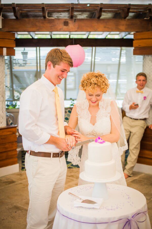 Kayla and Austin cut into their classic white cake topped with a single orchid, matching those in Kayla’s bouquet.