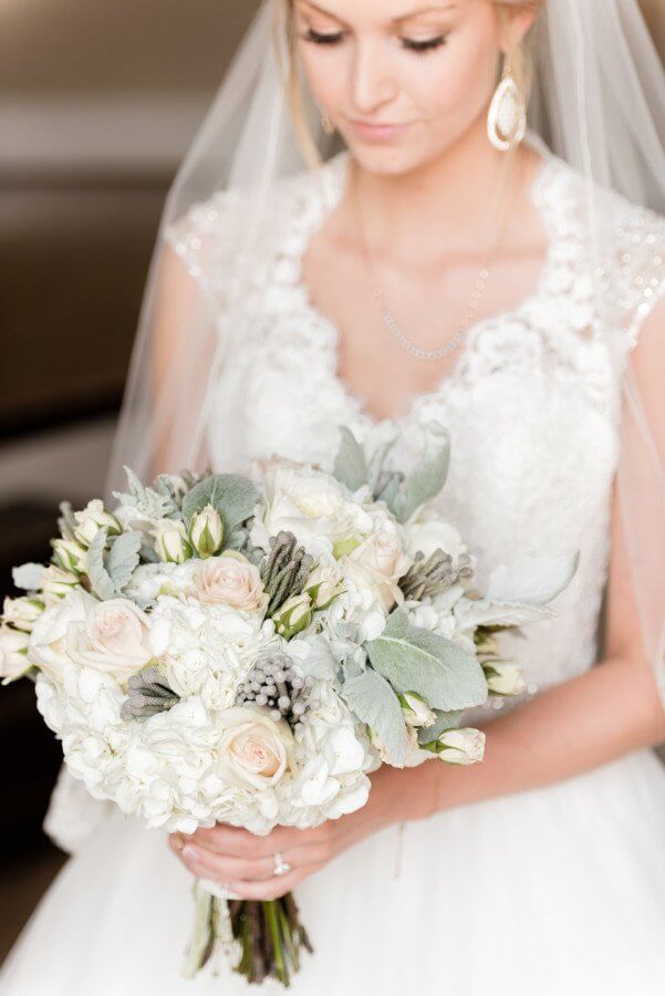 The bridal bouquet is beautiful in muted pinks and greens. The bridal bouquet is beautiful in muted pinks and greens.