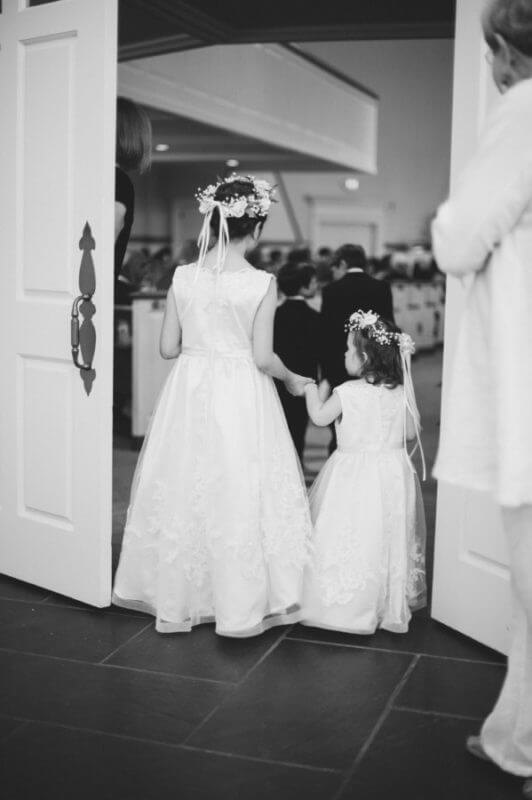 Lauren's nephews, acting as ringbearers, lead the way for the flower girls. 