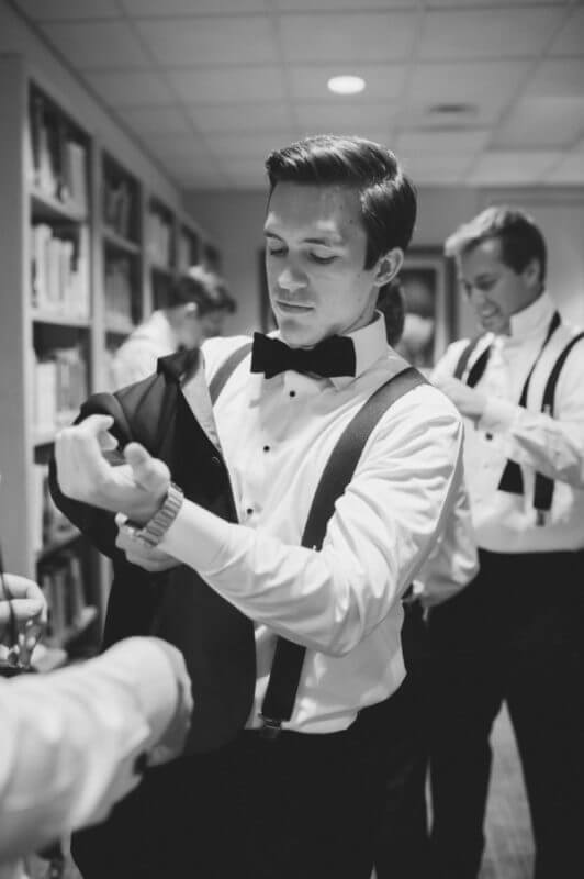 John and his groomsmen donned tuxedos from The Black Tux and suspenders monogrammed with their initials.