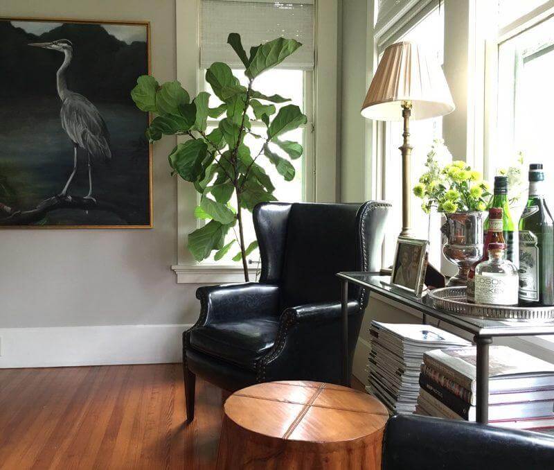 “One thing I did on the cheap to make this room different was to hand paint the match-stick blinds white,” says the designer. The 1940’s black leather wing chairs belonged to her grandparents. “One thing I did on the cheap to make this room different was to hand paint the match-stick blinds white,” says the designer. The 1940’s black leather wing chairs belonged to her grandparents.