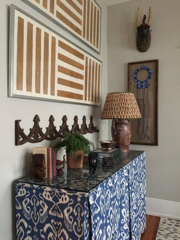The blue skirted table in the living room was made to hide a console Hunter had before they got married, she explains. “It wasn’t anything special, so I covered it with a Robert Allen (robertallendesign.com) blue fabric, and styled it in a way we could still access drawers, but making it fit more into the vibe of the room,” she says. Artistic treasures around it include a framed traditional bead necklace that was a gift from the Maasai while her husband was filming a documentary in Africa. (Adds Meredith: “He was presented with it after he drank cows’ blood!”) The blue skirted table in the living room was made to hide a console Hunter had before they got married, she explains. “It wasn’t anything special, so I covered it with a Robert Allen (robertallendesign.com) blue fabric, and styled it in a way we could still access drawers, but making it fit more into the vibe of the room,” she says. Artistic treasures around it include a framed traditional bead necklace that was a gift from the Maasai while her husband was filming a documentary in Africa. (Adds Meredith: “He was presented with it after he drank cows’ blood!”)