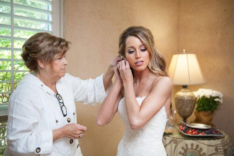  Lauren’s mom helped put the final touches on Lauren’s classic wedding day look.
