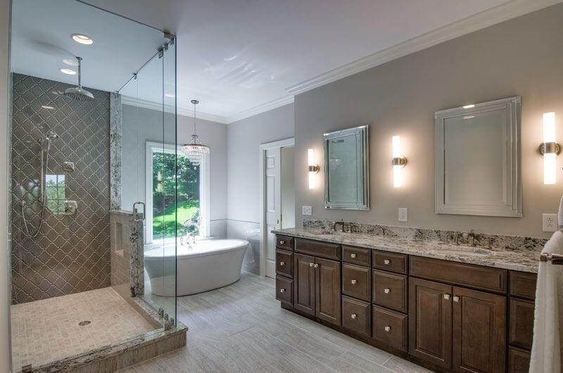 Enjoy a relaxing soak in the tub while enjoying the views of nature, or opt for the spacious stand-up glass shower. His and hers vanities, plenty of storage and beautiful fixtures complete this amazing space.