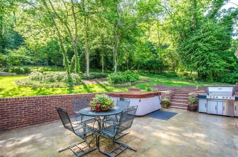The back patio includes a hot tub, beautiful garden beds and plenty of space to entertain.