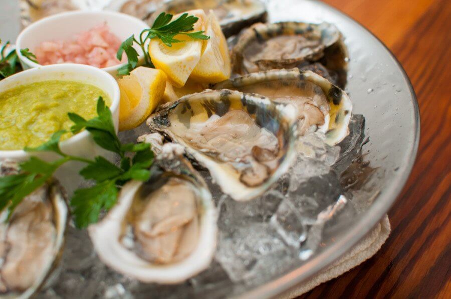 Raw oysters with homemade green tomato cocktail and apple-ginger mignonette at The Depot | Image: Philip Darden Raw oysters with homemade green tomato cocktail and apple-ginger mignonette at The Depot | Image: Philip Darden