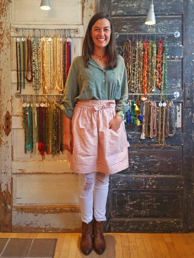 Perch employee Katie-Gray stands before a wall of beads. Perch employee Katie-Gray stands before a wall of beads.