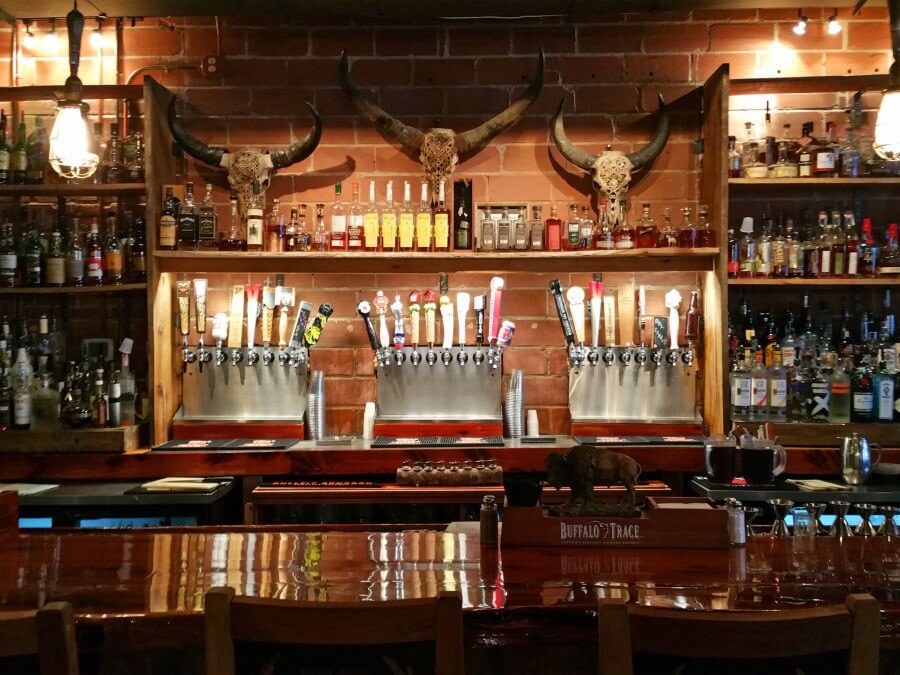 The bar at The Hound features reclaimed wood, longhorns and Edison bulbs for a one-of-a-kind look! The bar at The Hound features reclaimed wood, longhorns and Edison bulbs for a one-of-a-kind look!