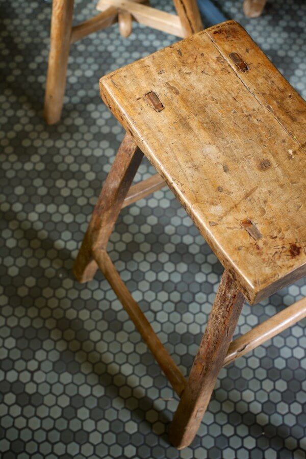 Caroline picked the tile floor, in varying shades of gray mosaic, and is delighted that most people think it is original to the home. 