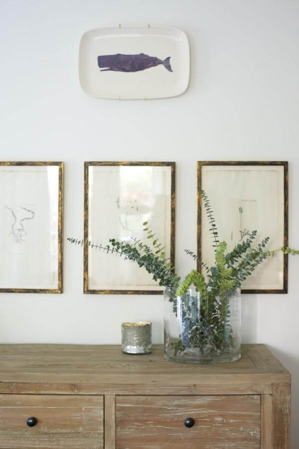 This lovely asymmetrical wall vignette is anchored by Command strips. "I always use Command strips so I can easily change it as I add or take away," says Caroline.