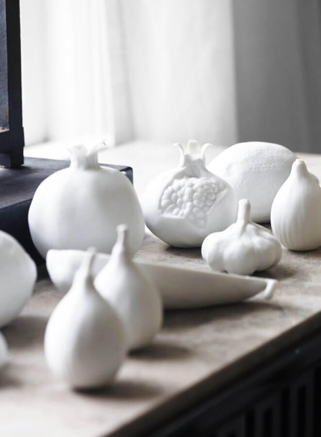 Vegetable figurines in white make for a lovely side table vignette. Image: Jean Allsopp