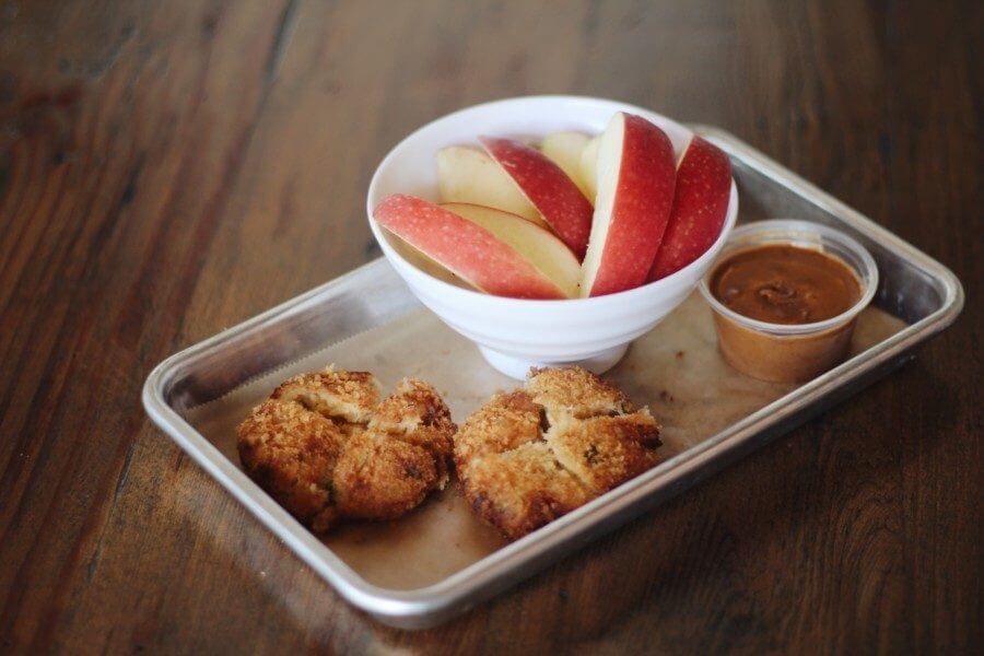 Flounder cakes served with a side of apples and almond butter from the Real & Rosemary kids' menu | Image: Louis Fort Flounder cakes served with a side of apples and almond butter from the Real & Rosemary kids' menu | Image: Louis Fort