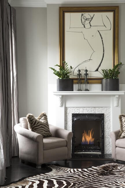 “I have carried that zebra rug from house to house for years,” says Brandon. The master sitting area also highlights a painting he bought off of igavel.com.