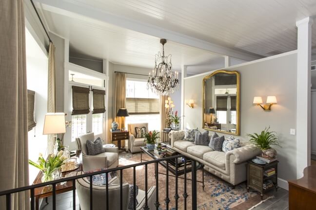 Brandon bought the chandelier in this second sitting room from a mansion on Forsyth Park. He enjoys the hunt for one-of-a-kind pieces, such as this Louis Phillip mirror he found at a favorite antique store in Savannah called Seventh Heaven (antiquesinsavannah.com); the rug was an ebay find.