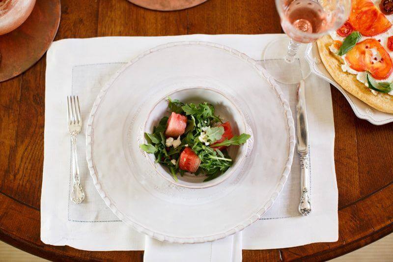 A plate, linen napkin and vintage flatware illustrate laid-back luxury.