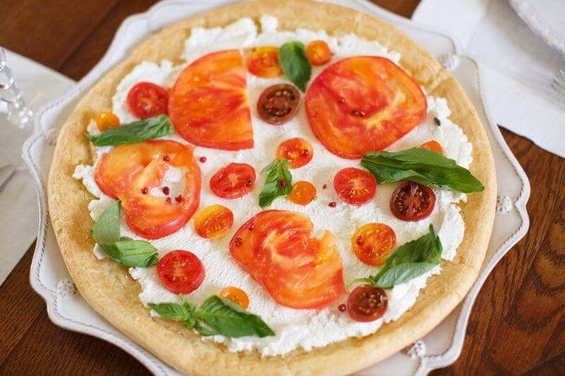 Put your bounty of summer tomatoes to good use in an heirloom tart with fresh ricotta, basil, pink peppercorns and plenty of in-season tomatoes.
