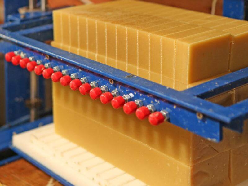 Soap is sliced into even bars.