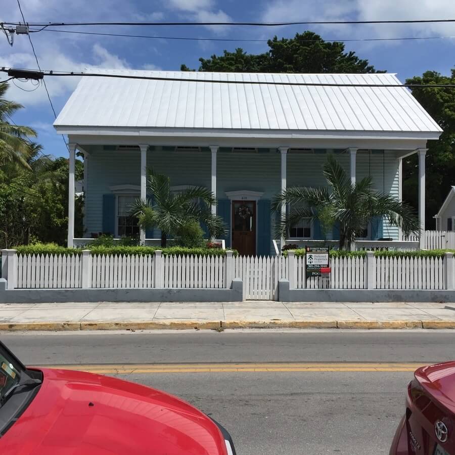 On this eyebrow house, you can barely see the bottoms of the second story windows peeking out beneath the "eyebrow" roof.